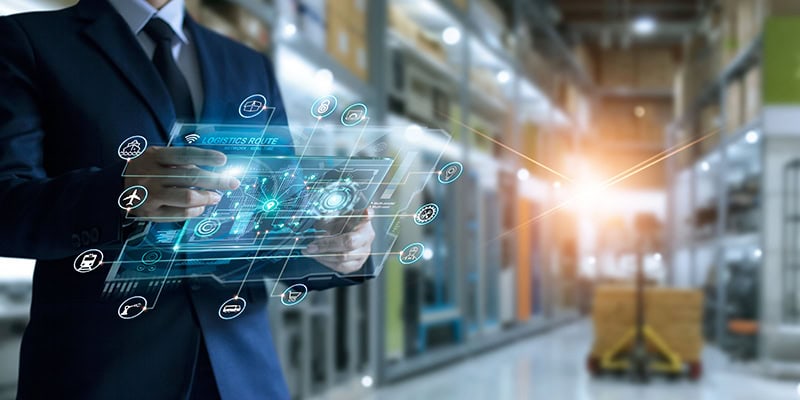 Businessman holding virtual interface panel of global logistics network distribution and transportation, Smart logistics, Innovation future of transport on large warehouse center background.