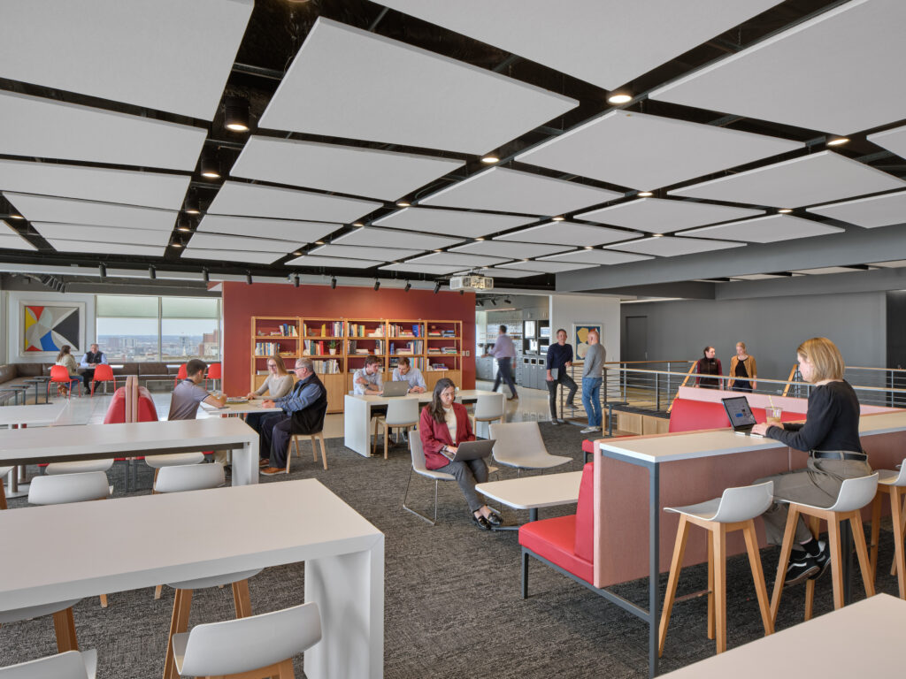 What distinguishes high-performing compact offices is not the number of amenities but their relevance. When features align closely with how employees actually work – eating lunch, plugging in quickly, meeting informally – they enhance satisfaction while preserving valuable space. In one workplace, a cafe designed to support multiple functions illustrates this approach. 